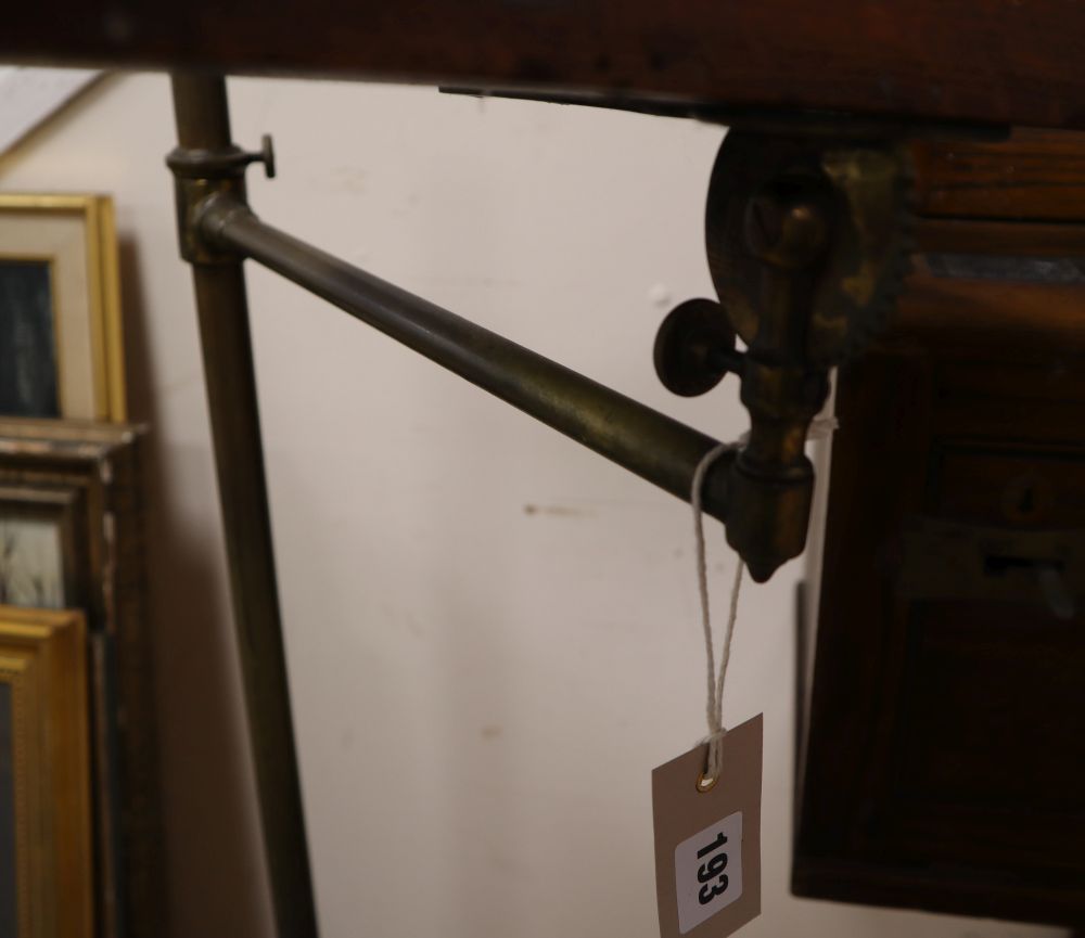 A late Victorian brass and cast iron adjustable lectern, with an oak reading slope, height 124cm